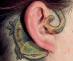 Tatuaje de lagartija en la oreja