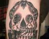 Skull illusion tattoo
