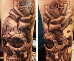 Realistic skull with cross and rose
