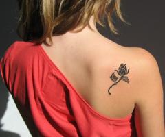 Black rose tattoo on the back