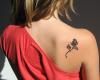 Black rose tattoo on the back