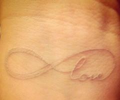 White ink tattoos on tan skin