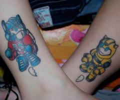 Couple transformers tattoos