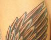 Paper clipped wing tattoo