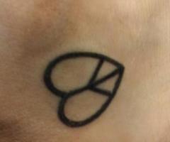 Peace and love symbol tattoo on foot