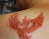 Ave fenix en la espalda con tribales