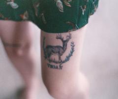 Deer and vegan tattoo on leg