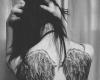Black and white wing tattoo