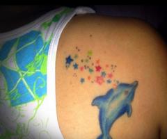 Dolphin and stars tattoo