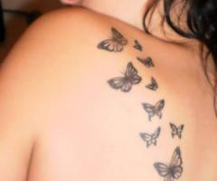 Tattoos mariposas en espalda de mujer