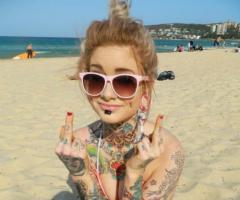 Sexy girl on beach with tattoos