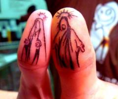 Jesus vs Mary thumb tattoos