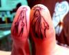 Jesus vs Mary thumb tattoos