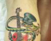 Slash as snake guitar tattoo