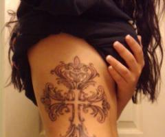 Cross tattoo on the rib