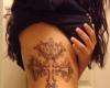 Cross tattoo on the rib
