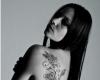 Long vine with hanging roses inked all across the side back