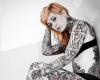 Displaying many old school tattoos, which are inked all over her body