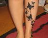 Black butterfly silhouettes with splashing color, looking fabulous on leg
