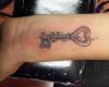 Key with heart-shaped loops and shimmering stars in nice shade work