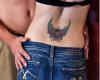Colorful sacred heart tattoo with wings and the eternal black flame