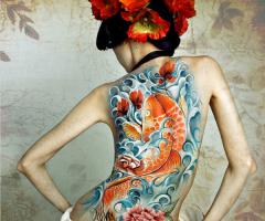 Stunning colors on this full back koi with sparkling waves in the background