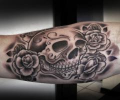Stylish sugar skull with a cluster of roses done in dark shade