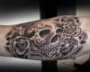 Stylish sugar skull with a cluster of roses done in dark shade