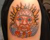 Colorful and vibrant tribal sun and a sobbed face shedding down tears