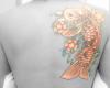Beautiful, glowing koi and blossoms curved over her upper back
