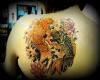 A black and a golden koi placed like Yin Yang, with lotus flowers
