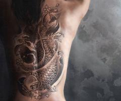 Stunning full back piece of a traditional koi fish done with fantastic dark shade work