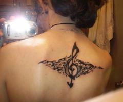 Another tasteful twist to treble clef symbol done by attaching to it the tribal wings