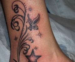 Sleek, wavy tribal swirls with butterflies and stars