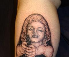 Marilyn Monroe with a gun tattoo