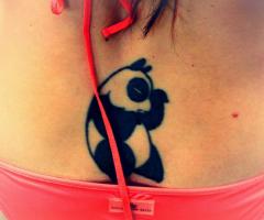 Panda tattoo on lower back