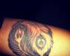 Yin and yang with feathers tattoo