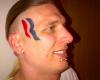 Eric Hartsburg shows off his shiny Romney tattoo
