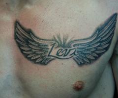 Wings dedication tattoo