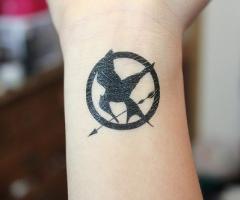 The hunger games logo tttoo