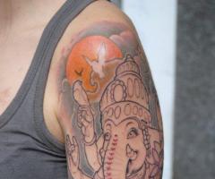 Ganesh arm tattoo