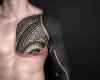 Black and decorative arm tattoo