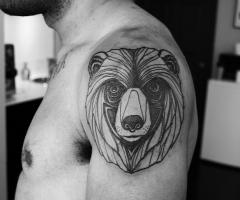 Bear line tattoo on shoulder