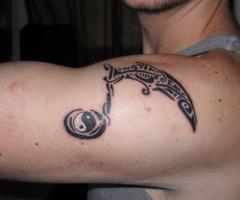 Music tribal with yin yang symbol tattoo