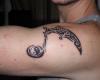 Music tribal with yin yang symbol tattoo