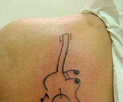 Acoustic guitar tattoo