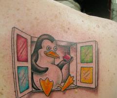 Tux sitting on Windows eating an Apple tattoo
