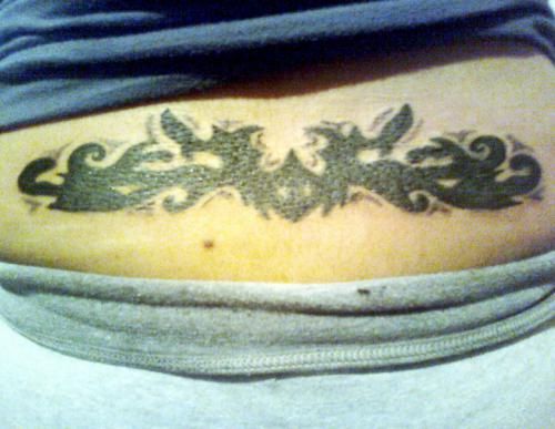 Tribal lower back tattoo