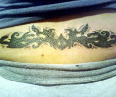 Tribal lower back tattoo