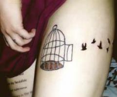 Aviary thigh tattoo